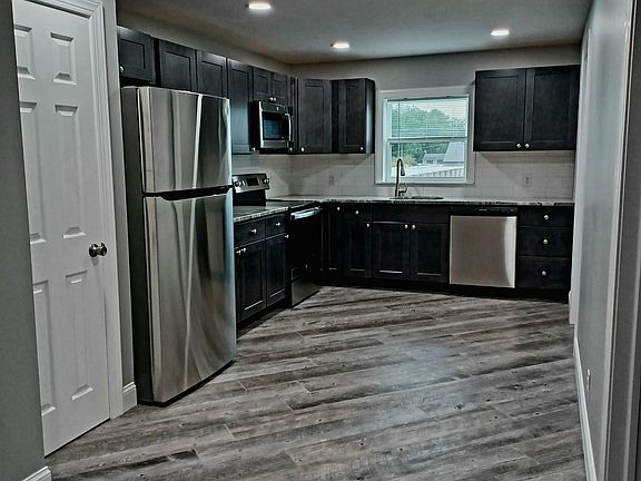 Modern kitchen with stainless steal appliances, ceramic tile flooring. Large pantry. Laundry room offers more storage as well as storage in utility closet.