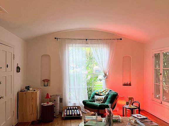 Another view of living room with bay window and Spanish nooks.