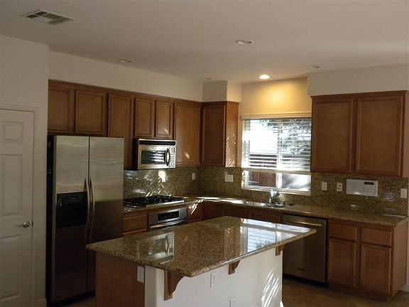 Stainless steel kitchen with granite countertops, full splash