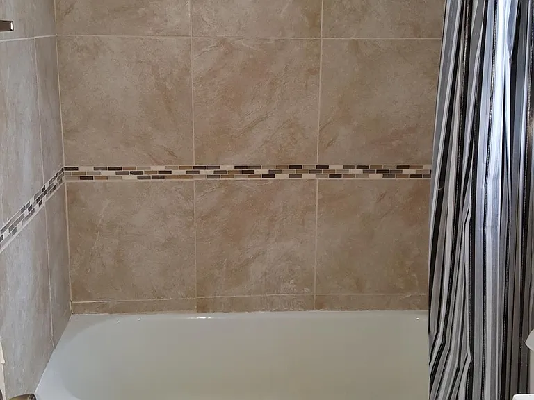 Tiled Full bath with tub and shower