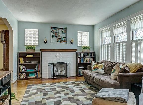 Beautiful living room with stain glass windows, block windows, and fireplace.