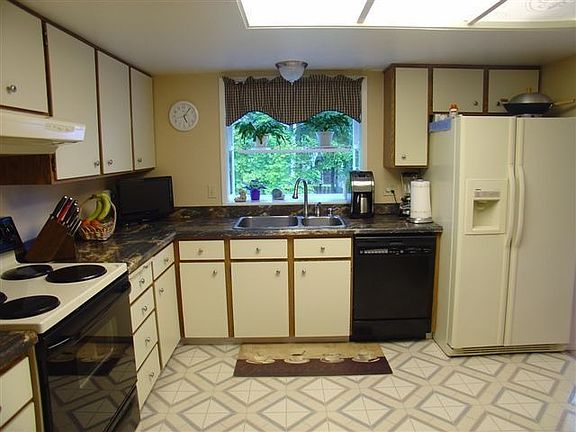 Spacious kitchen with garden window to private backyard. Additional cabinets and built-in desk compl