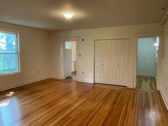 Alternate view of living room / dining room facing kitchen and entry.