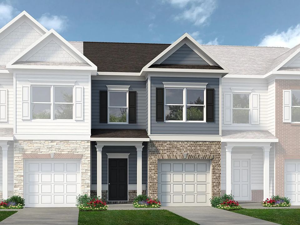 Right at the front, the home features a clean, modern exterior with brick and siding accents, professional landscaping, and a welcoming covered entry_making a strong first impression before you even step inside.