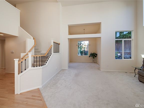 Vaulted ceilings in the living room lets in lots of natural light. Architectural details lead into the formal dining room. Exten