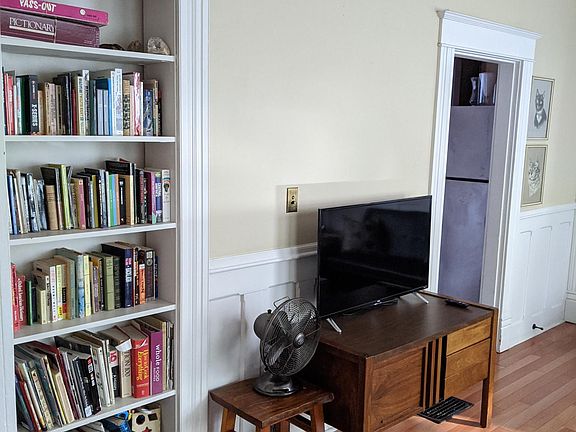 Stocked bookshelf and smart TV with Amazon Prime and Netflix logged in