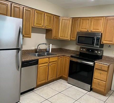 Stainless appliances including a glass stovetop and dishwasher