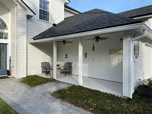 Covered front porch with lighted ceiling fans