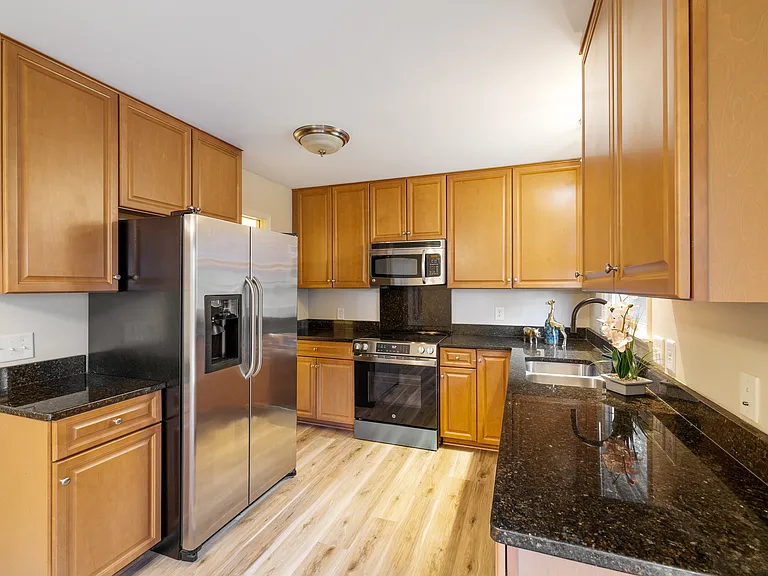 Kitchen; granite countertops, upgraded appliances; half bath tucked into back corner
