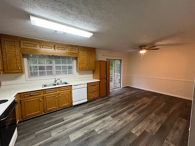 Large kitchen & dining space that is open to the living room and a patio deck and large, private backyard.