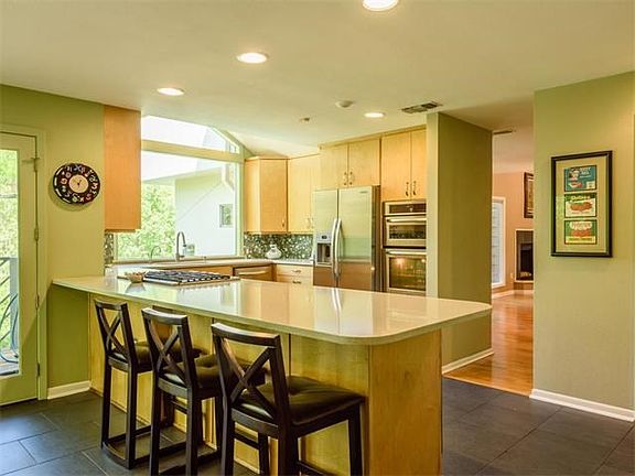 For those who love to cook and entertain, the kitchen has gas cook top, stainless steel appliances, a wine fridge, double ovens and warming drawer, as well as custom cabinets and large pantry.
