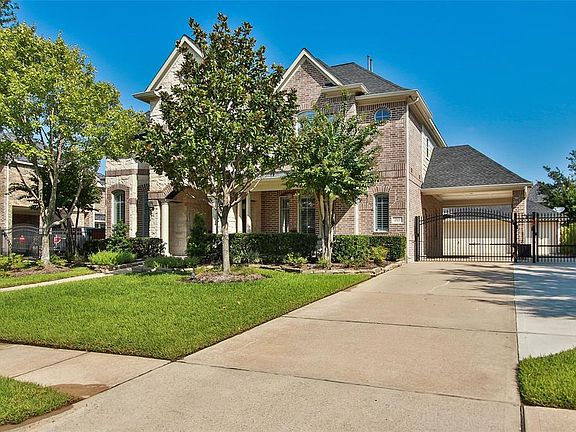 Great parking available in this extended driveway with double swinging entry gates. 3 CAR GARAGE IS EXTRA DEEP FOR A TRUCK TO FIT and workshop. Pull down stairs for above storage and is decked out.Efficiently arranged storage!