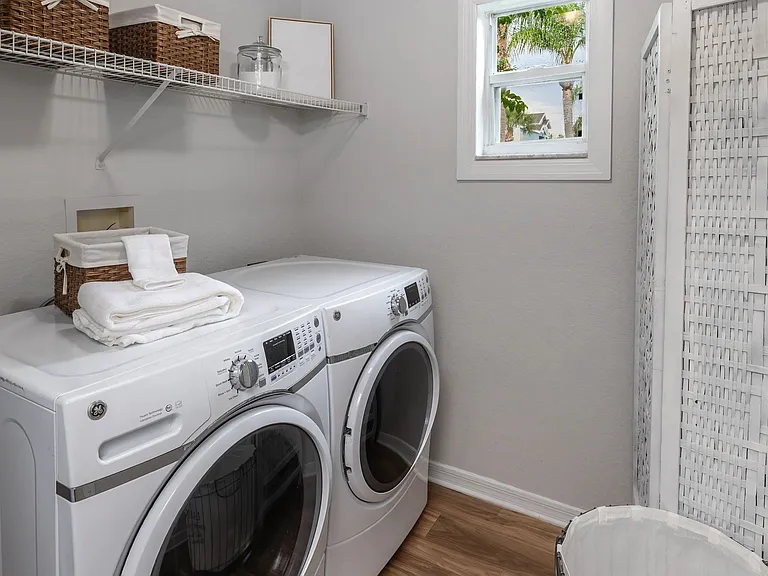 Enjoy the convenience of in-home laundry with a full-size washer and dryer, plus built-in shelving to keep everything organized.