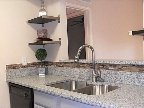 Kitchen has been updated with beautiful granite counters, stainless steel sink, and new faucet.  Open shelving is a nice addition to this lovely kitchen.