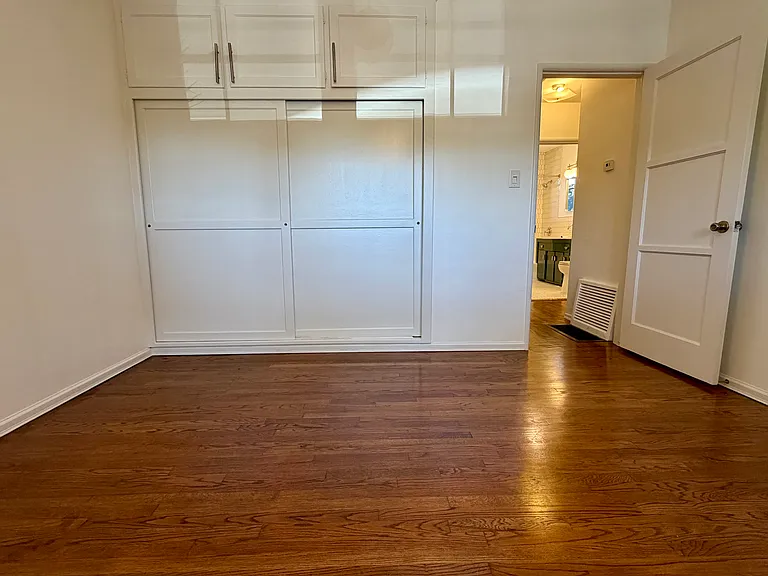 Large closet with three large cabinets above.