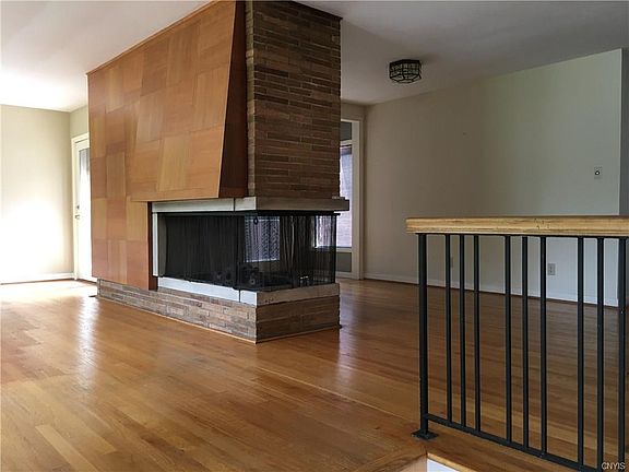 Up a few steps, enter the front living room- with formal dining room on other side of fireplace wall.