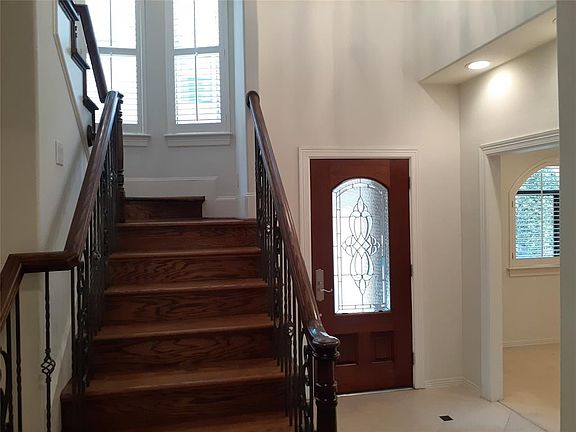 Entry and grand staircase. Stone entry way. Opening is into the first floor den.