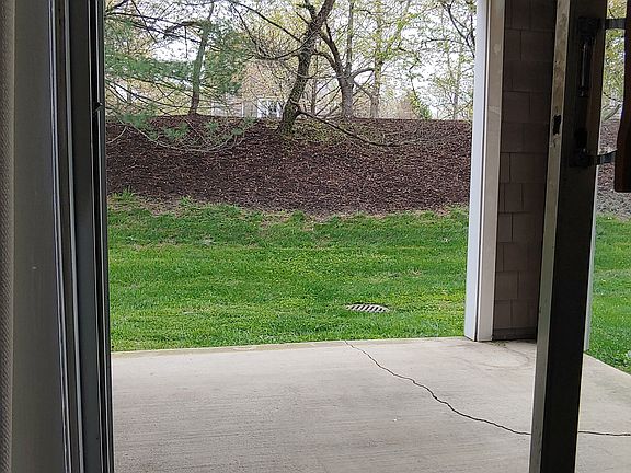Large patio opens to private garden area with storage closet