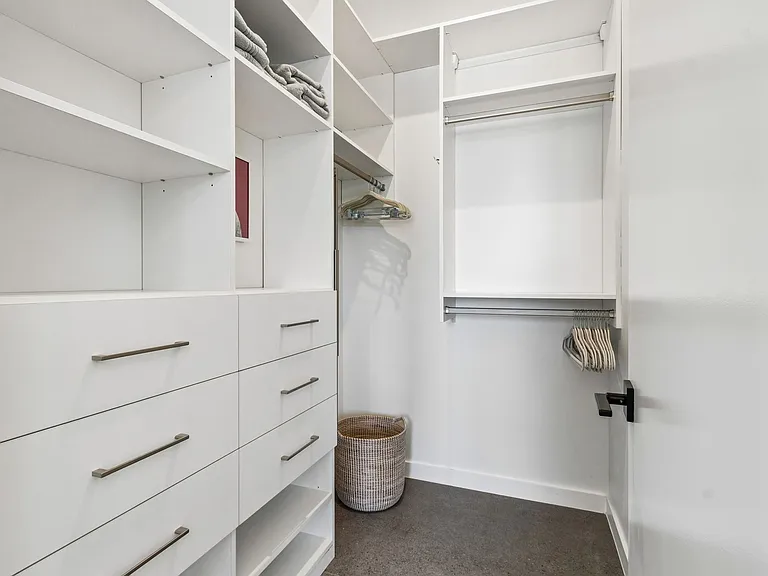 Walk in closet in primary bedroom