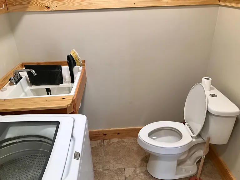 Utility room located off the kitchen. Tile floor.