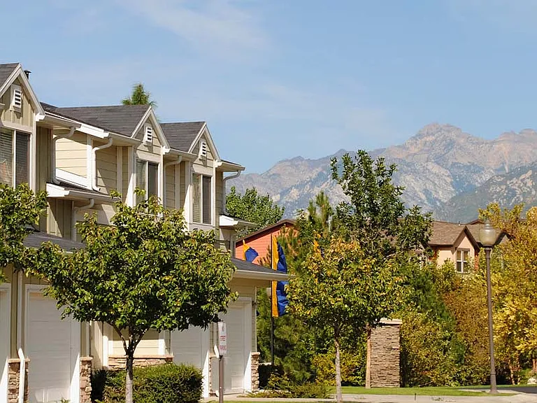 Liberty Hill Apartments, Draper, Utah, row of houses with trees in front and mountains in the background.