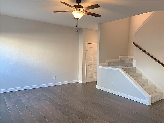Wide-plank wood grain tile floors downstairs. Fresh interior paint throughout.
