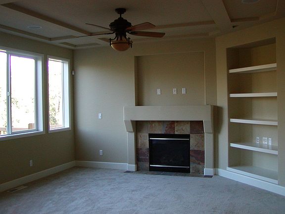 Family Room features 55" TV niche above fireplace and whole-house sound