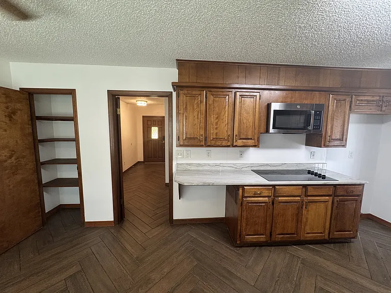 East side view of Kitchen. Pantry on left