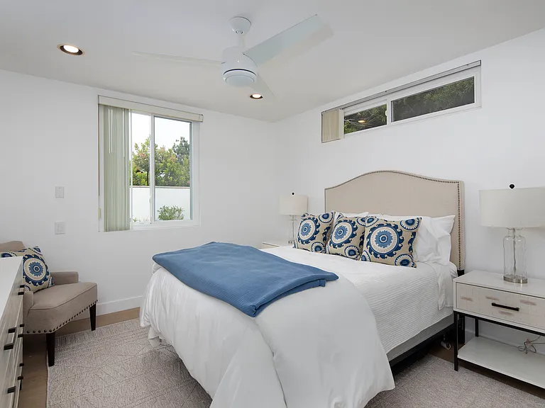 Downstairs guest bedroom features a queen size bed and large closet