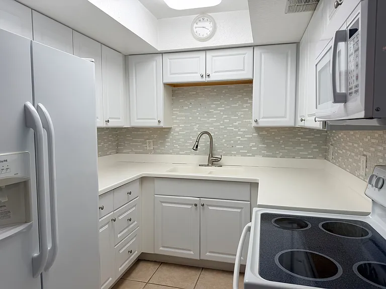 KITCHEN WITH FILTERED WATER IN THE REFRIGERATOR.;