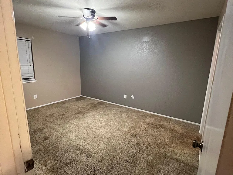 One of the two bedrooms with carpet