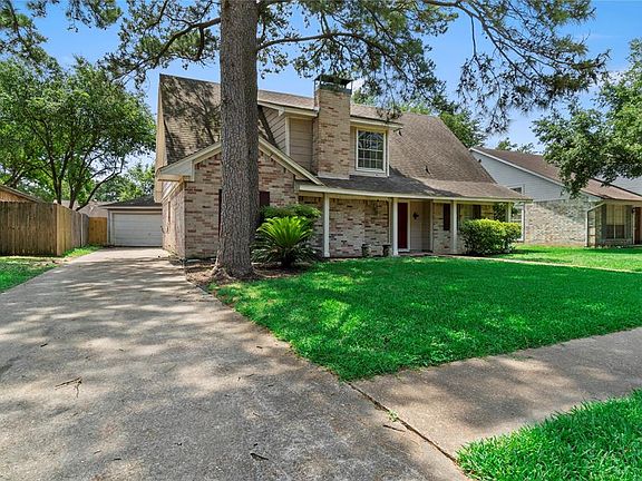 Long driveway leads to the 2 car detached garage