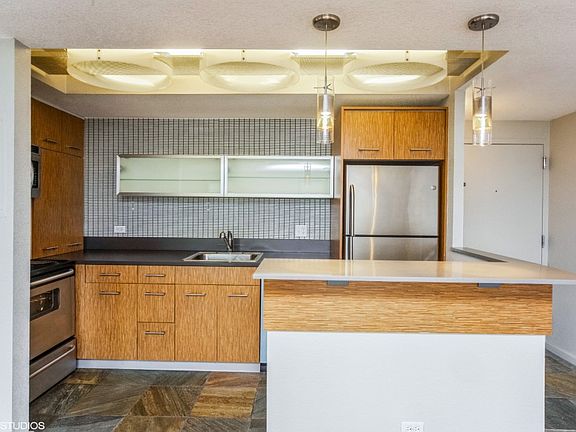 Chic accents in the upgraded kitchen including pendant lighting over the breakfast bar