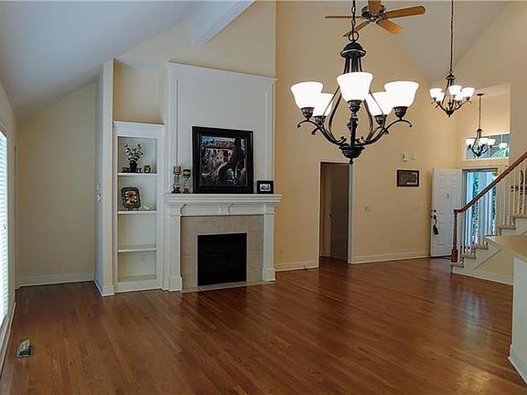 Beautiful builtin bookshelves and stunning fireplace with switch.  Love the vaulted ceiling!