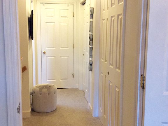 Master suite upstairs hallway with three closets