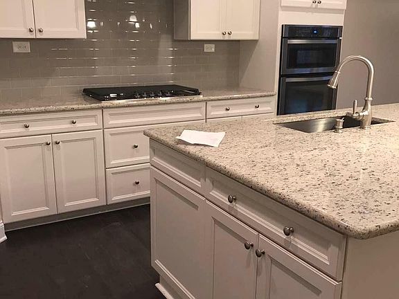 Kitchen: White top line cabinet, granite counter top, glass back splash
