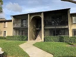 Walkway from the parking lot to the condo, located on the second floor of the left side. The assigned parking spot is immediately adjacent to the sidewalk allowing for easy access.