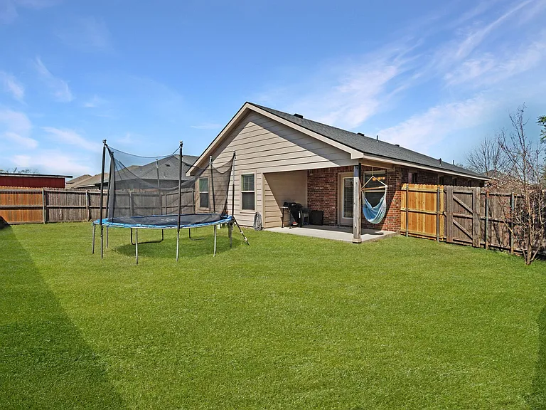 The covered patio has plenty of room for grilling and socializing