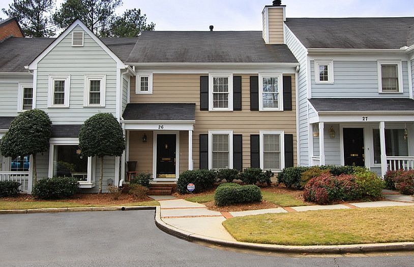 Pristine 2/2.5 townhome has fresh paint, wood floors and crown molding. 