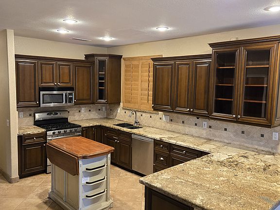 Large kitchen with cherry cabinetry and stainless appliances.