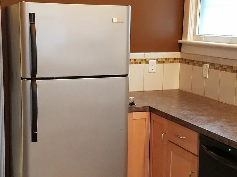 Clean modern appliances including a dishwasher,refrigerator and glass top stove. Coin-operated laundry in basement.