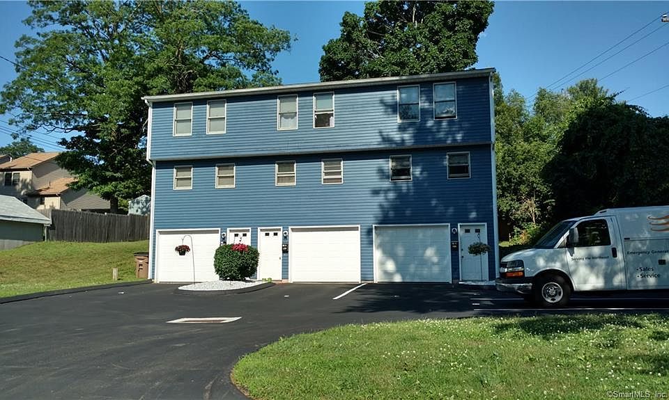 Front of house with private garage and entrance for each unit. Yours is end unit on right.