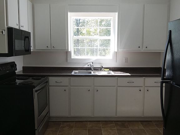 Appliances include stove, microwave and refrigerator