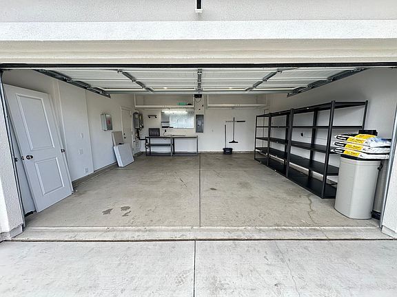 Plenty of storage, work bench, steel tool hanging boards, & water softener system