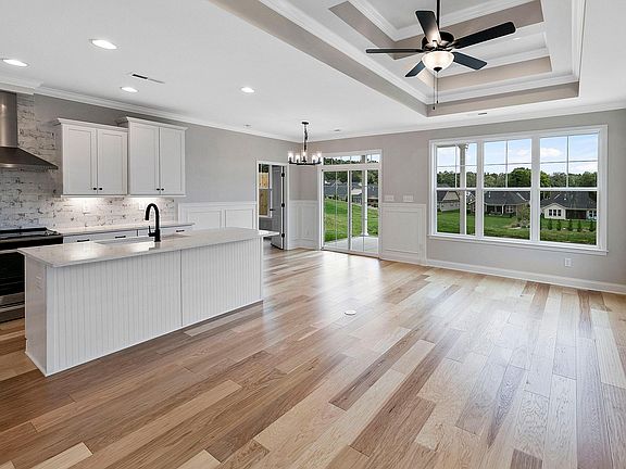 Quartz countertops and slide in range with designer hood
