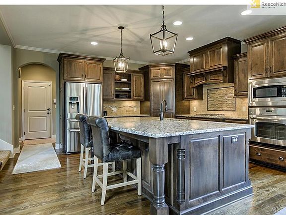 Kitchen with custom lighting and over sized island for work or entertaining