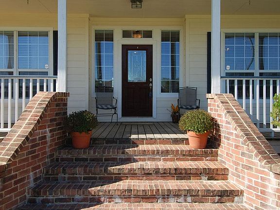 Welcoming front stairs open into wrap around porches front and back.