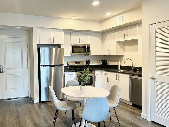 Stunning and sunny kitchen with stainless steel appliance package, washer & dryer, extra storage and modern finishes at The Centennial, 10555 Bloomfield - The Centennial
