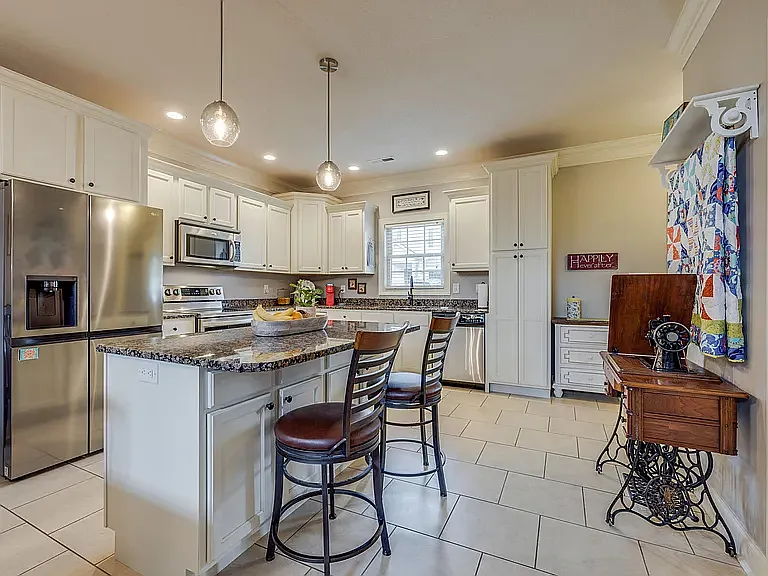 Kitchen with Stainless Steel Appliances and Oversized Refrigerator / Freezer & Island