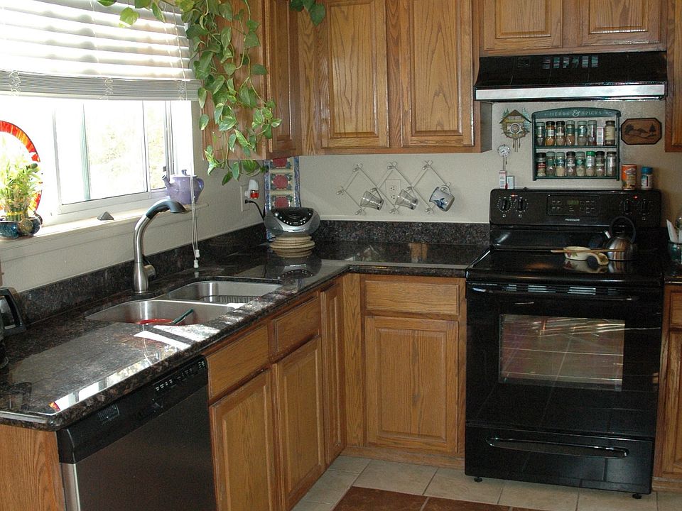 Kitchen with new stove and new dish washer, custom tile. Red oak cabinets